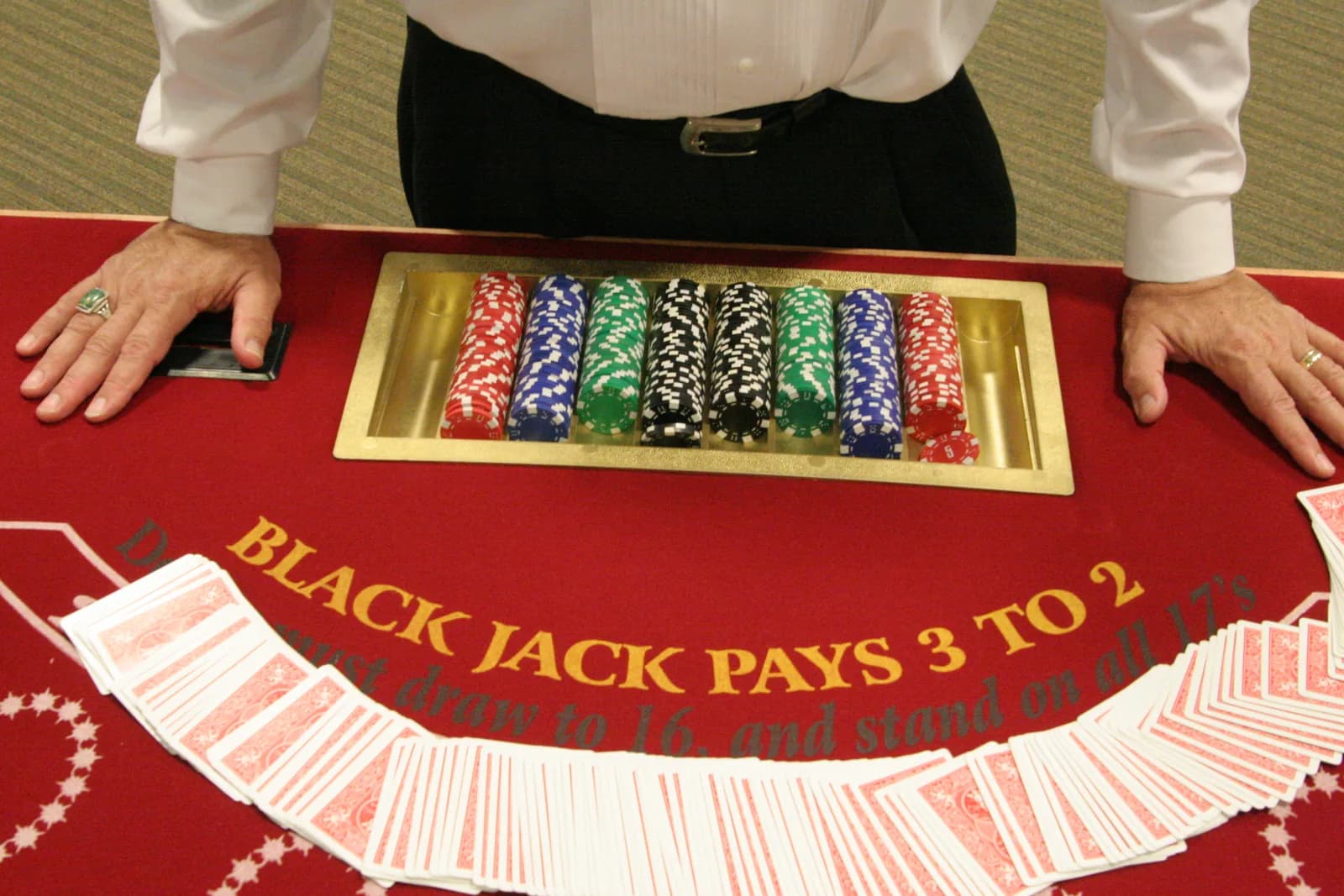 Regulation blackjack table with casino chips and 'Blackjack Pays 3 to 2' felt at an MC Casino Gaming event