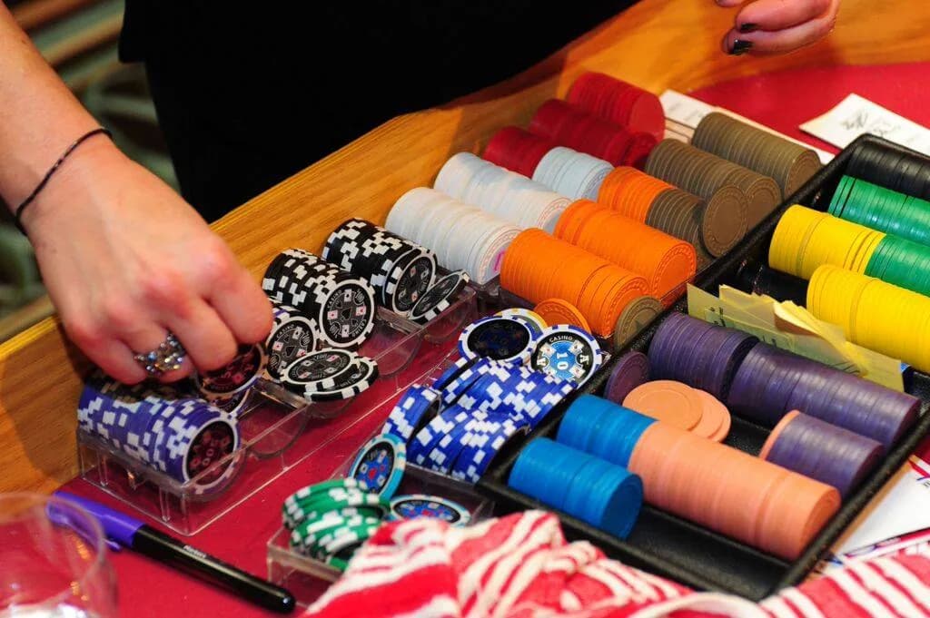 Close-up of colorful casino chips in a dealer tray at a casino night rental