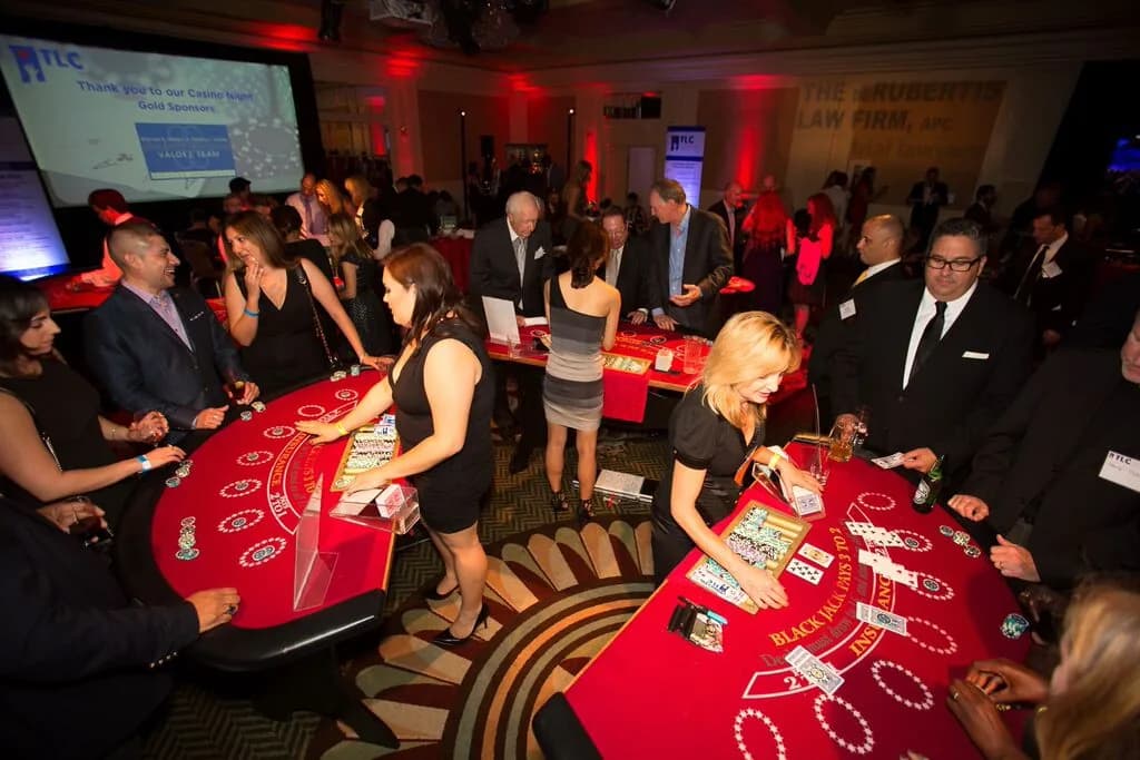 Guests gathered around a roulette table at the LA Trial Lawyers Charities casino fundraiser