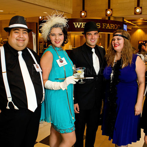 Event photography of the 24th Annual Great Gatsby Gala, presented by Wells Fargo and held at the Wells Fargo Atrium in Uptown Charlotte NC. Guests raise funds for MS while also reliving the days of the "Roaring 20s" and enjoying beverages and food from local Charlotte restaurants showcasing their culinary specialities.